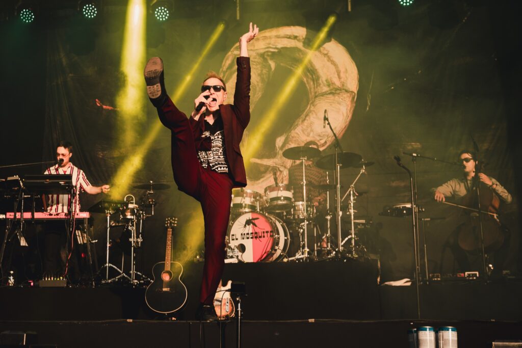 Image of a Finnish artist called Ismo Alanko with a backdrop in the background