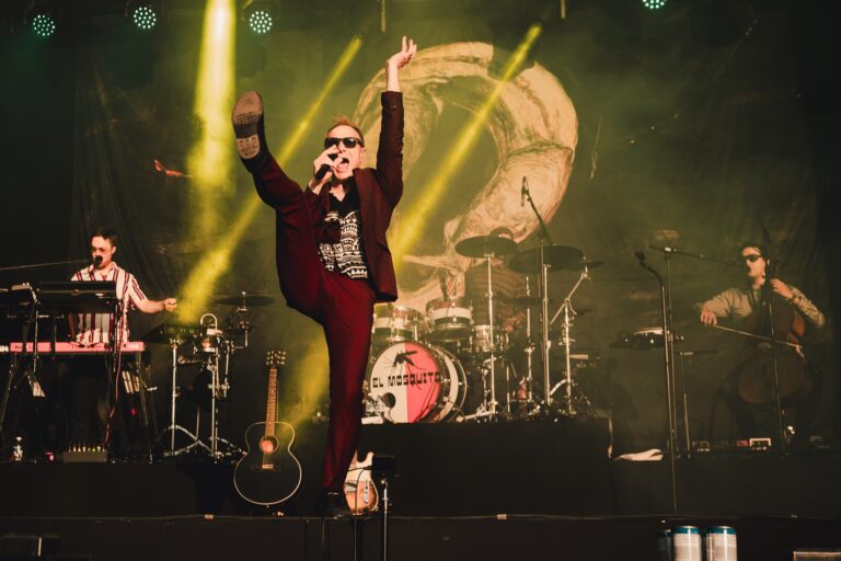 Image of a Finnish artist called Ismo Alanko with a backdrop in the background