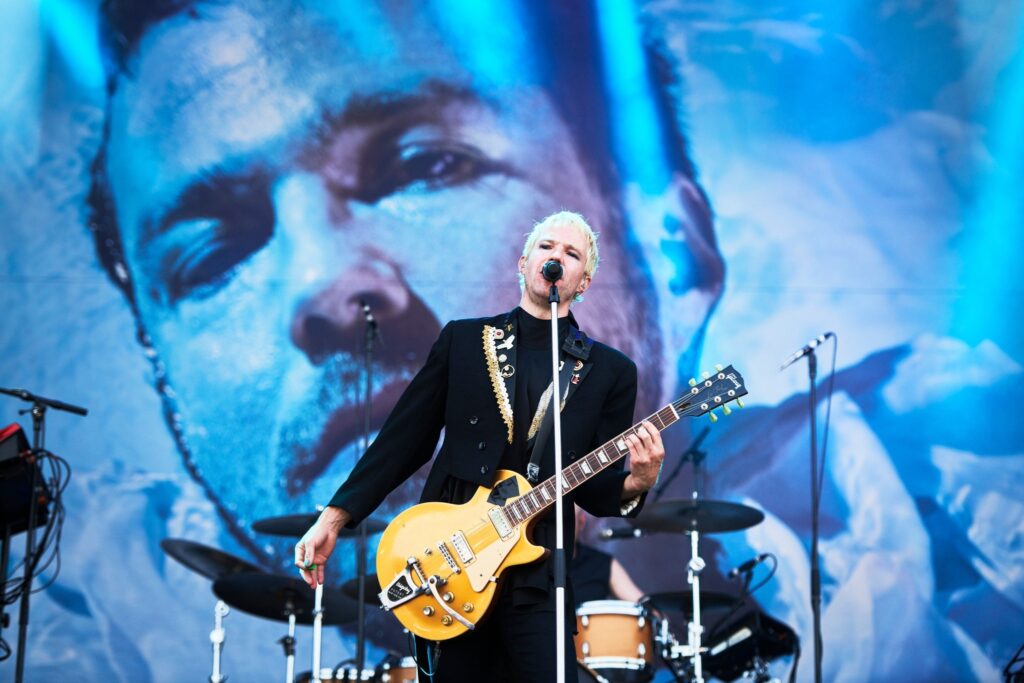 Image of a Finnish band called Olavi Uusivirta with backdrop in the background