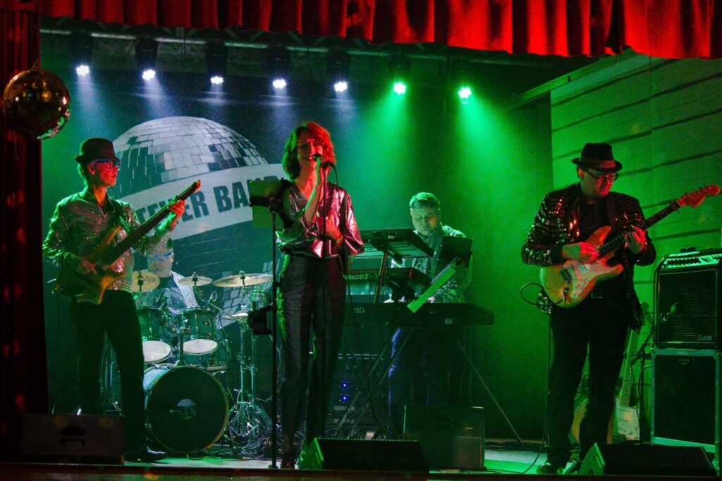 Image of a Finnish band called Whatever Band with their 4 x 2 meter (13 ft x 6.6 ft) size backdrop in the background